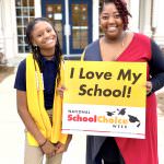 Anderson Creek student and adult smile with school choice sign